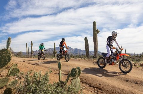 3 OHV motorcyclists on a Cactus lined path